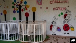 Empty cribs at a playhouse in the courtyard of Kherson regional children's home in Kherson, southern Ukraine, Friday, Nov. 25, 2022. (AP Photo/Bernat Armangue)