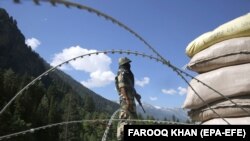 An Indian paramilitary soldier stands guard at a check post along a highway leading to Ladakh, at Gagangeer, some 81 kilometers from Srinagar, the summer capital of Indian Kashmir, on June 17, 2020. 