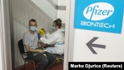 A man receives a second dose of the Pfizer-BioNTech vaccine against the coronavirus disease (COVID-19) at the hall three of the Belgrade Fair, in Belgrade, Serbia, April 13, 2021.