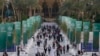 People walk through the COP28 U.N. Climate Summit, Monday, Dec. 4, 2023, in Dubai, United Arab Emirates. (AP Photo/Peter Dejong)