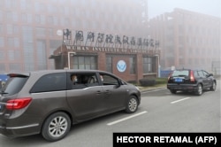 Members of the WHO team investigating the origins of the COVID-19 arrive at the Wuhan Institute of Virology on February 3, 2021.