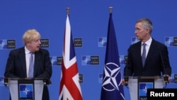 British Prime Minister Boris Johnson and NATO Secretary General Jens Stoltenberg hold a joint news conference at NATO headquarters, in Brussels, Belgium February 10, 2022. (Yves Herman/Reuters)