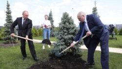 RUSSIA -- Russian President Vladimir Putin (Left) and Belarus President Alexander Lukashenko (Right) plant spruces at the Memorial to the Soviet Soldier, June 30, 2020.