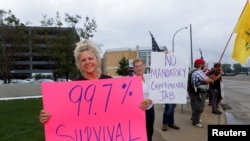 Sue Rowan, of Portage Lakes, Ohio, holds a sign to protest against the coronavirus disease (COVID-19) vaccine mandates at Summa Health Hospital in Akron, Ohio, U.S., August 16, 2021. Rowan had apprehensions about the vaccine, because, “…it’s not been tested."