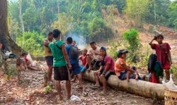 In this photo released by the Free Burma Rangers, Karen villagers gather in the forest as they hide from military airstrikes in the Deh Bu Noh area of the Papun district, north Karen state, Myanmar, on March 28, 2021.