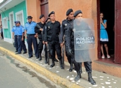 On July 8, 2019, riot police officers stand near the church in Jinotepe, where a religious service was held for demonstrators who died during 2018 protests against Nicaraguan President Daniel Ortega's government. (Oswaldo Rivas/Reuters)