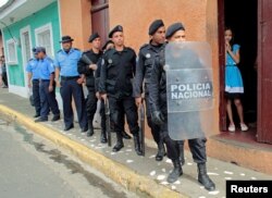 On July 8, 2019, riot police officers stand near the church in Jinotepe, where a religious service was held for demonstrators who died during 2018 protests against Nicaraguan President Daniel Ortega's government. (Oswaldo Rivas/Reuters)