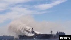 Smoke rises from a fire on board the U.S. Navy amphibious assault ship USS Bonhomme Richard at Naval Base San Diego, California, on July 12, 2020. Video of that fire has falsely been attributed to a Houthi attack in the Red Sea. 