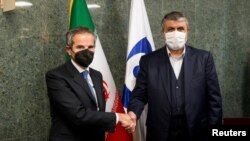 Head of Iran's Atomic Energy Organization Eslami meets with IAEA Director General Grossi in Tehran. (Reuters)