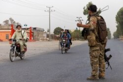 One of Danish Siddiqui's photos of an Afghan Special Forces soldier directing traffic during the rescue mission of a policeman besieged at a check post surrounded by Taliban, in Kandahar province, Afghanistan, July 13, 2021.